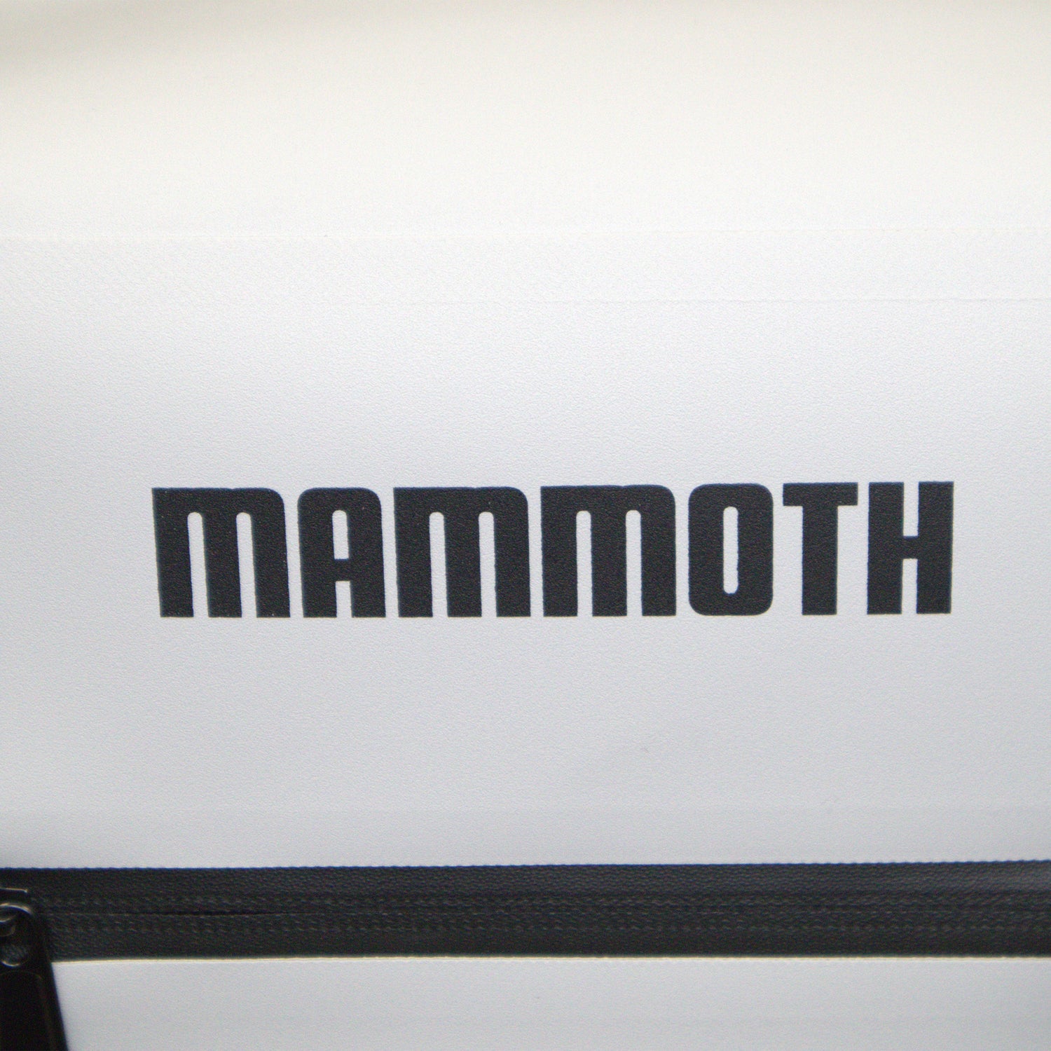 Close-up of a white bag with 'Mammoth' branding on a light gray background