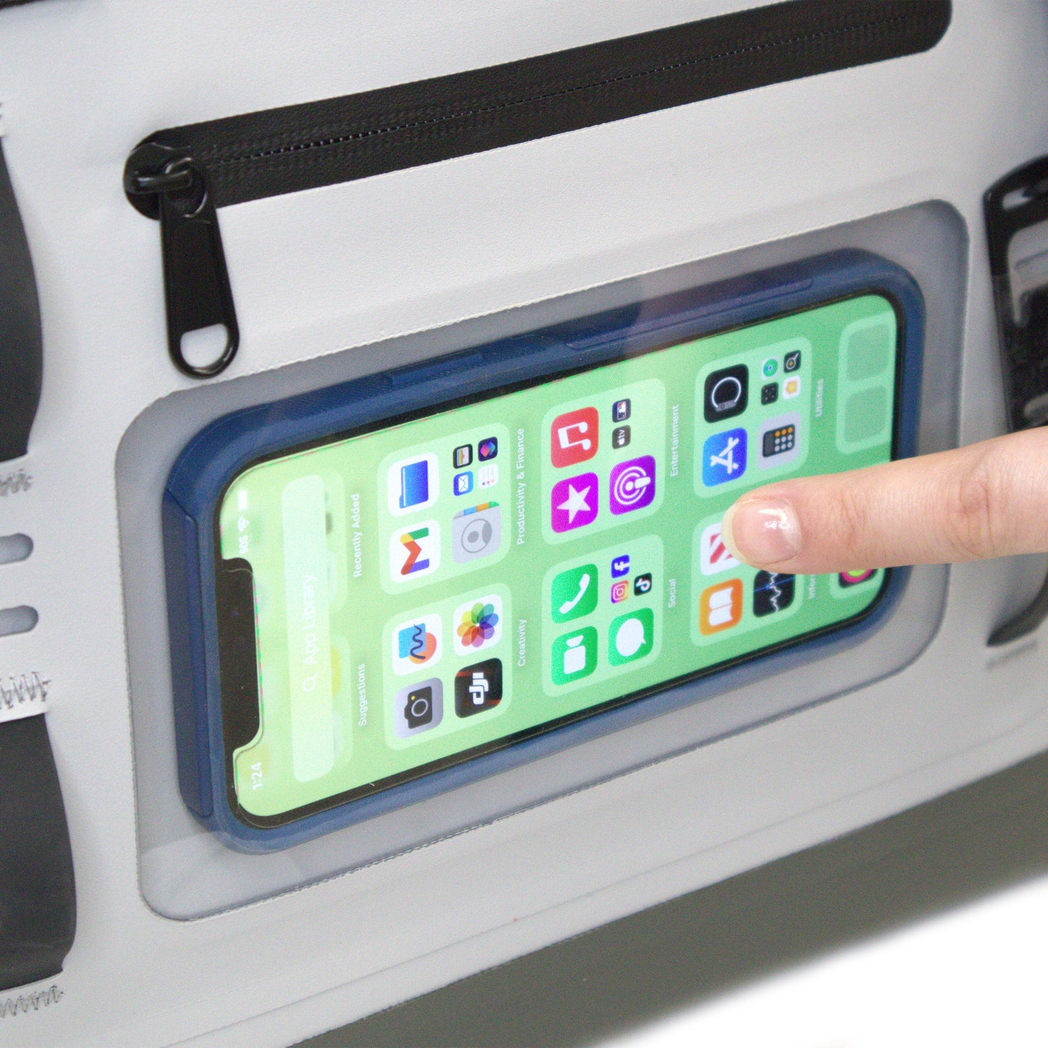 Phone with app icons in a compartment with a finger touching the screen