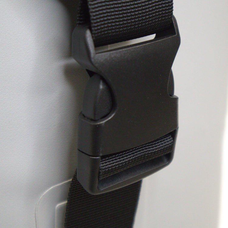 Close-up of a black strap with buckle on a gray background