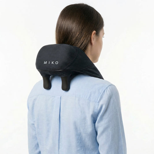 Black neck and shoulder massager with heating element on a white background