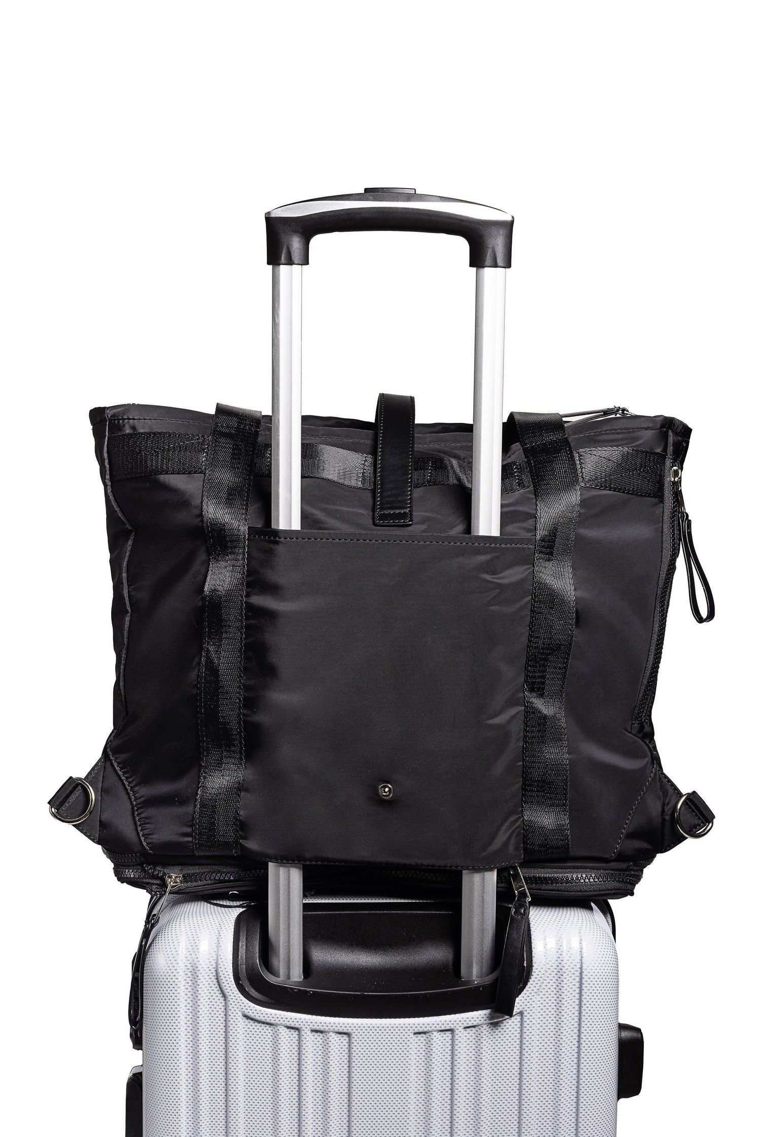 Black backpack on top of a white suitcase with a white background