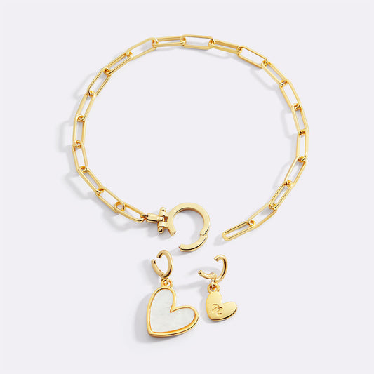 Gold bracelet with heart-shaped charms on a white background