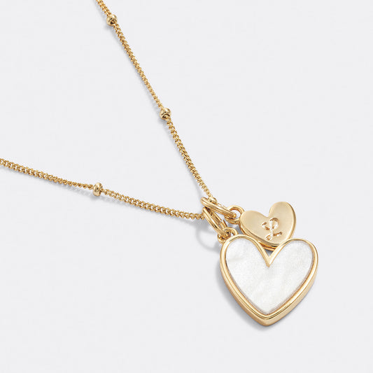 Gold necklace with a heart-shaped pendant on a white background