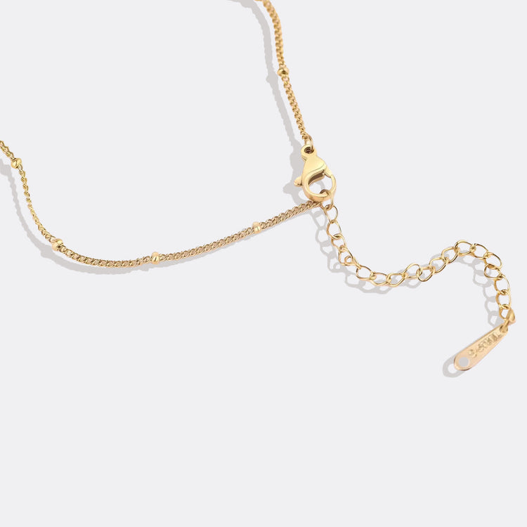 Gold chain bracelet on a white background