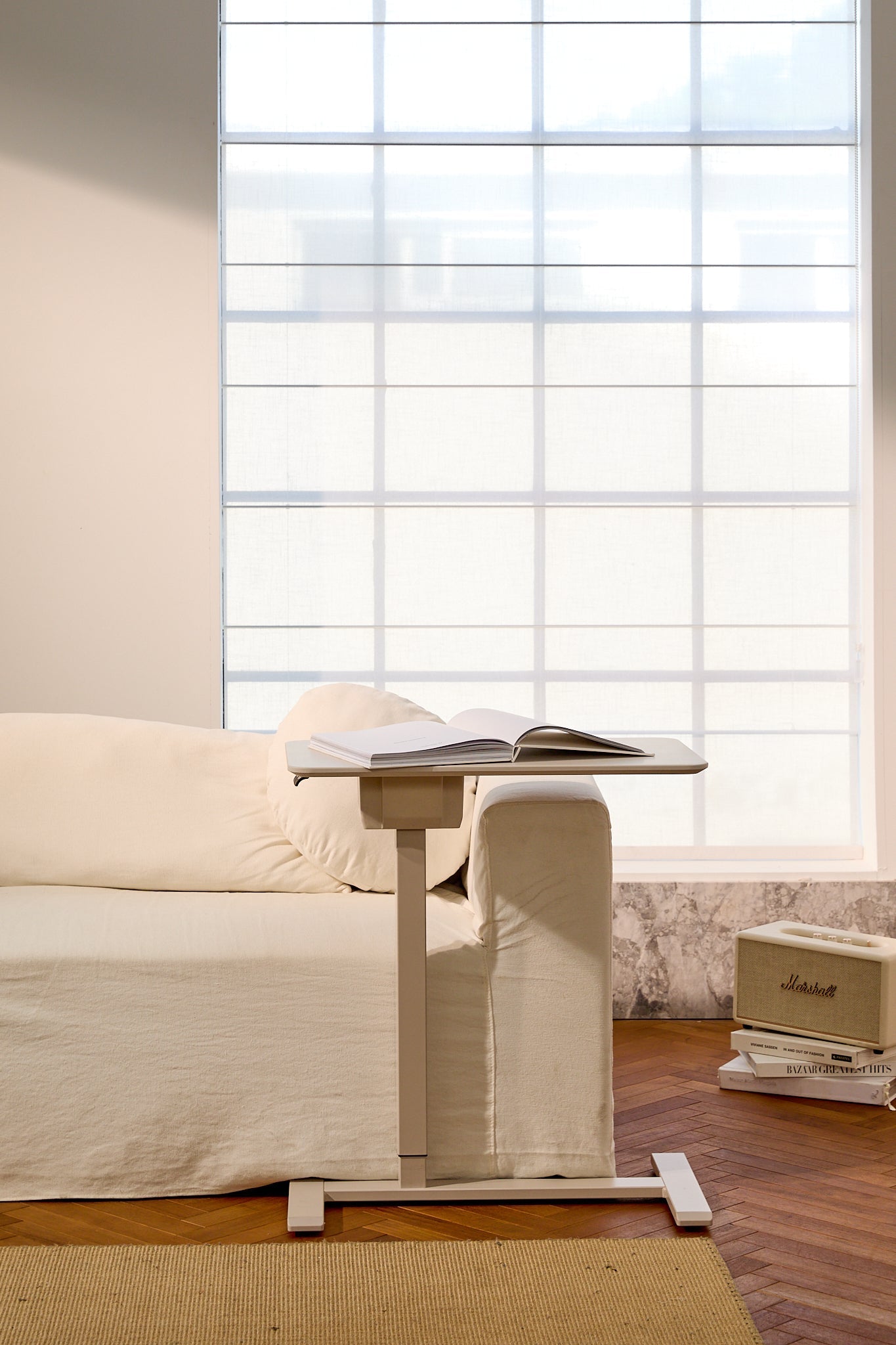 Sofa with a adjustable table in front of a large window