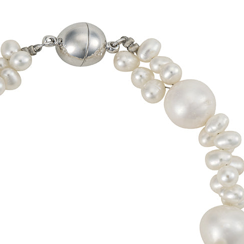 Pearl bracelet with silver clasp on a white background