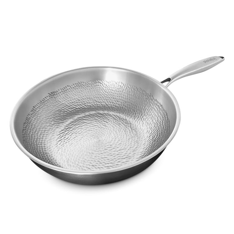 Stainless steel frying pan with textured surface on a white background