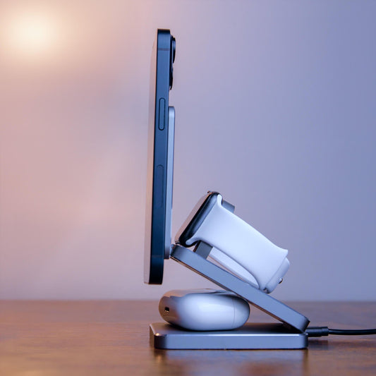 A foldable wireless charger stand with a smartphone, smartwatch, and earbuds being charged.