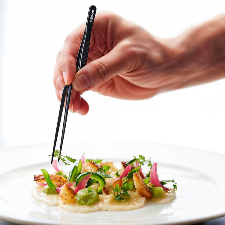 Hand using chopsticks to pick up a dish from a white plate