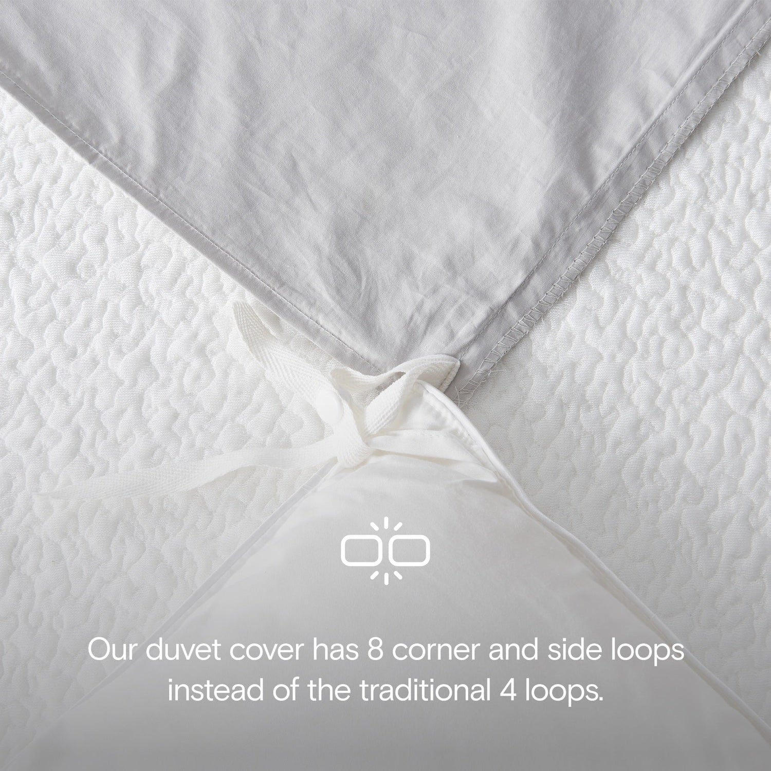 Close-up of a duvet cover with additional corner and side loops on a white background.