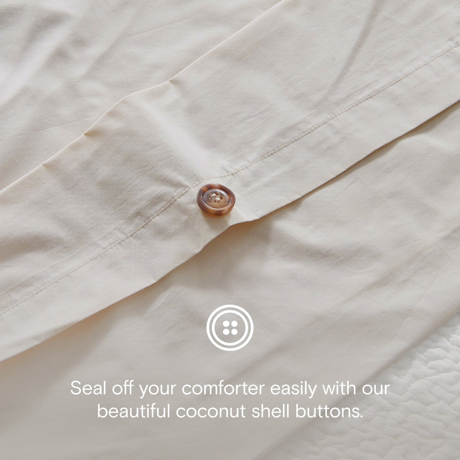 Close-up of a beige comforter with coconut shell buttons and text overlay.