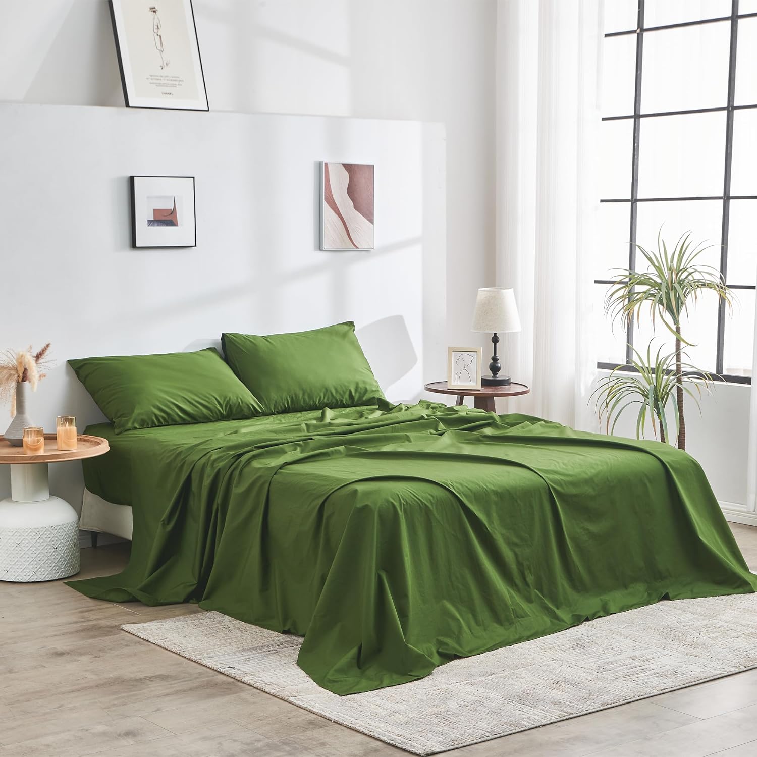 Green bedspread set on a bed in a bright bedroom with decor elements.
