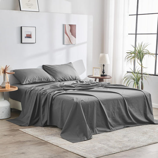 Gray bedding set on a bed in a modern bedroom with decor elements.