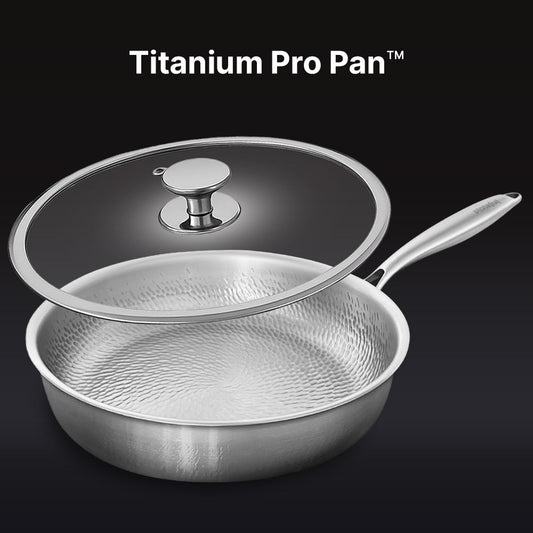 Set of stainless steel cookware including a frying pan, saucepan, and two smaller pots on a white background.