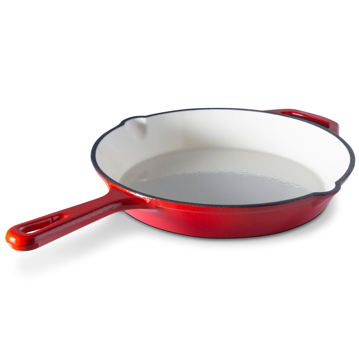Red enameled cast iron skillet on a white background