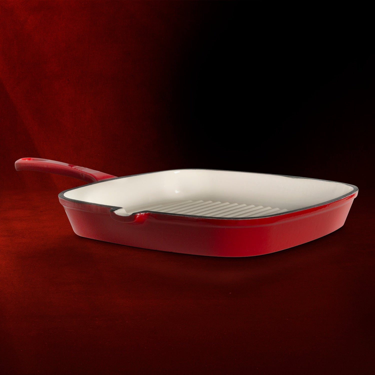 Red frying pan on a dark red background