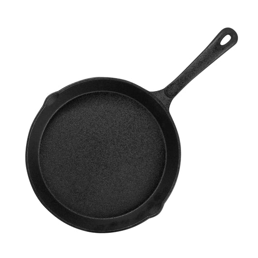 Set of three black cast iron skillets on a white background