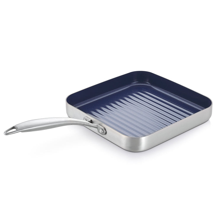 Stainless steel grill pan with blue non-stick coating on a white background