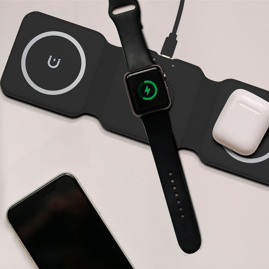 Black wireless charging pad with three circular pads on a white background