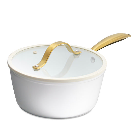 White ceramic pot with gold handle on a white background