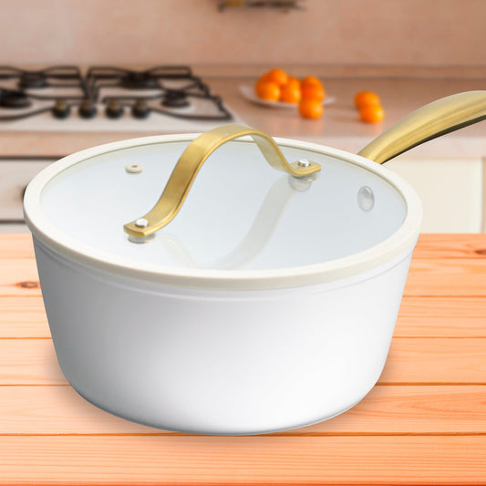 White ceramic pot with gold handle on a white background