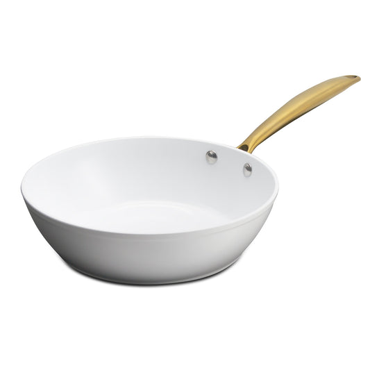 White frying pan with a gold handle on a white background