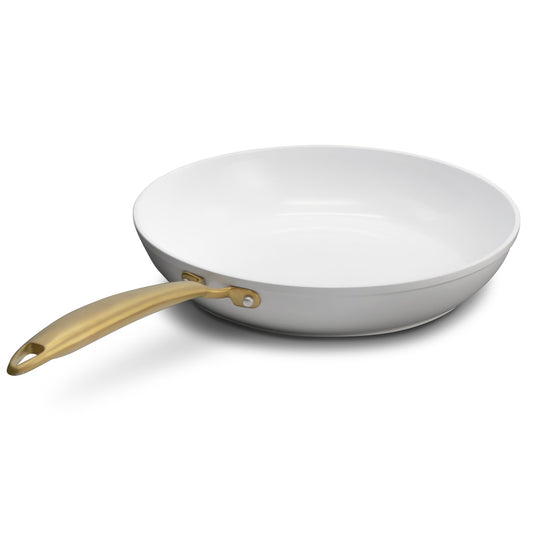 White wok with a gold handle on a white background