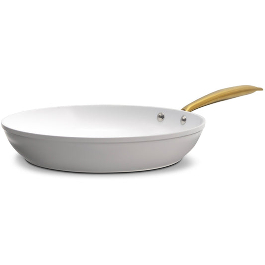 White wok with a gold handle on a white background