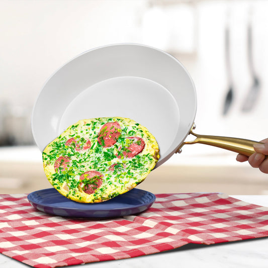 White wok with a gold handle on a white background