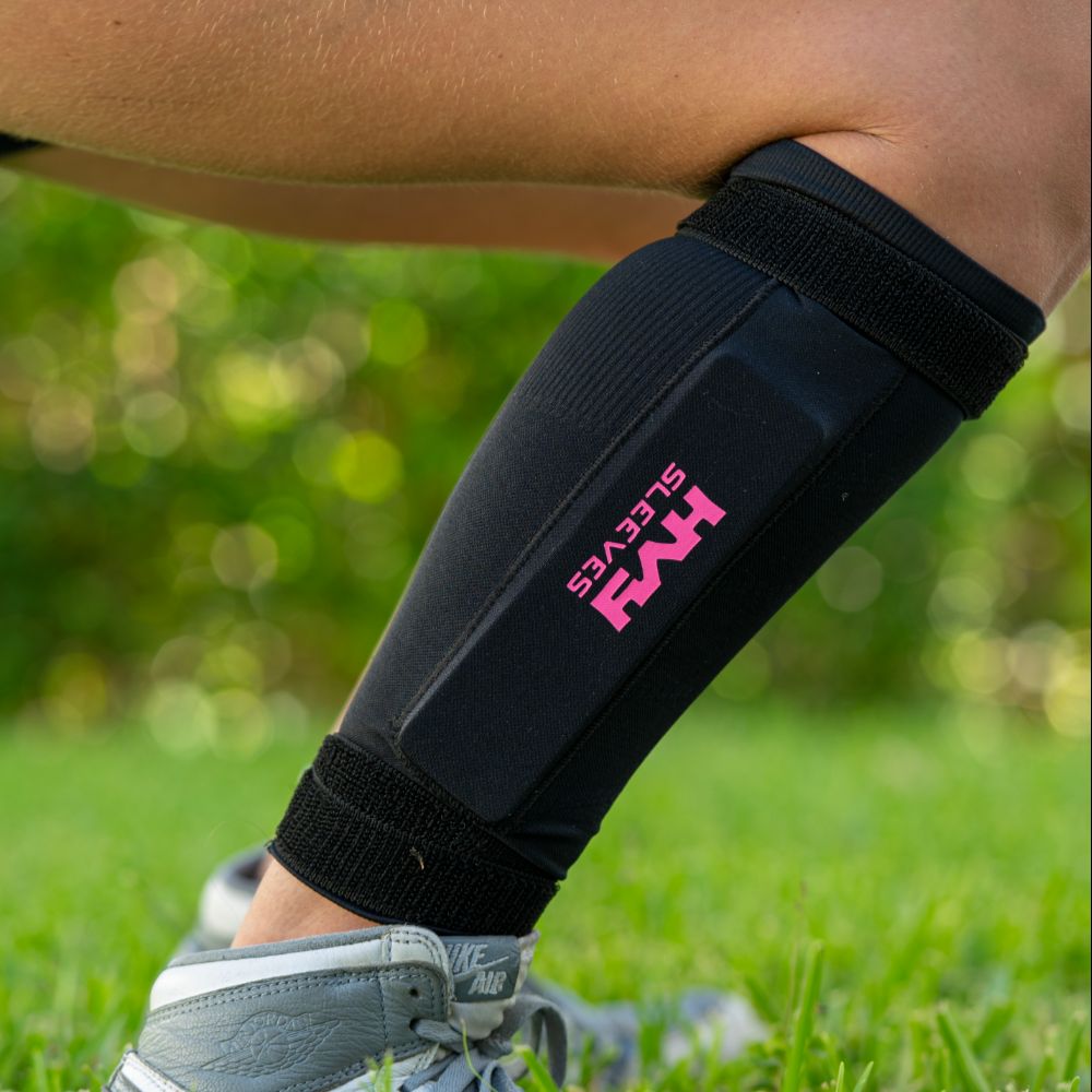 Black compression sleeve on a person's leg with 'HYPER' branding, outdoors.