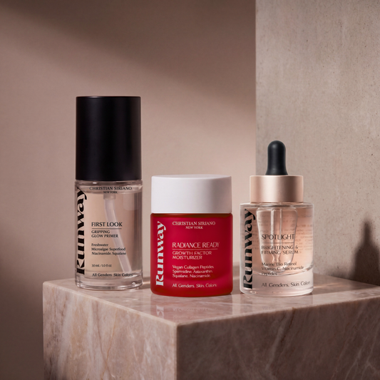 Three skincare products on a marble surface with a neutral background