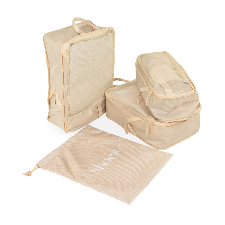 Set of beige packing cubes and shoe bag on a white background