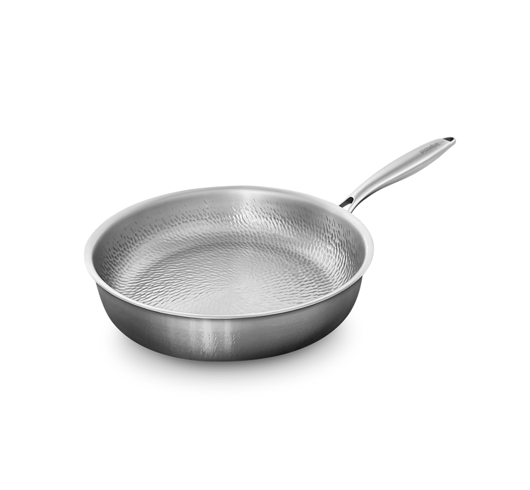 Stainless steel frying pan with textured surface on a white background
