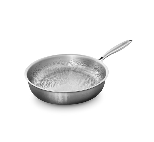 Stainless steel frying pan with textured surface on a white background