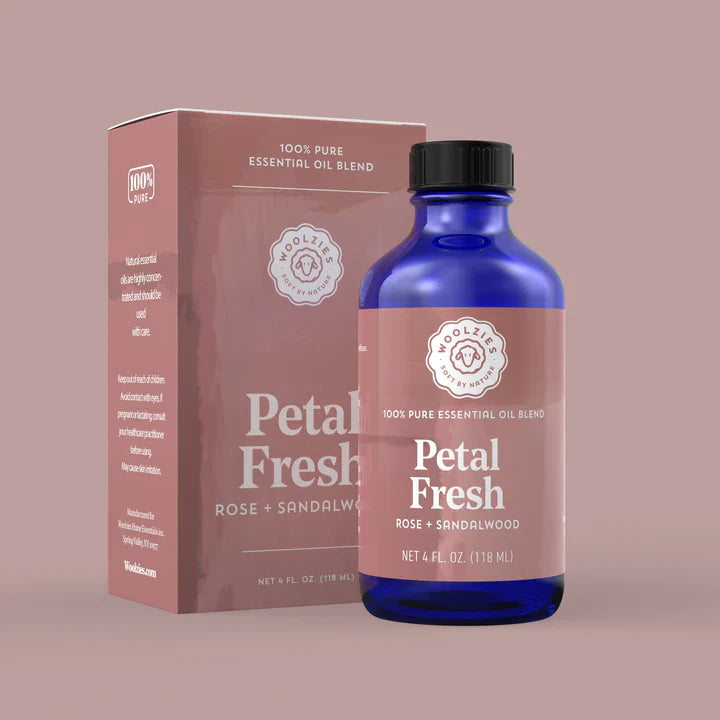 Bottle and box of Petal Fresh essential oil blend on a beige background