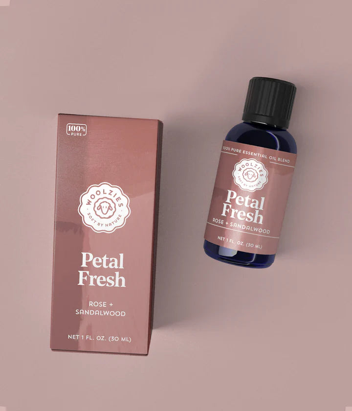 Bottle and box of Petal Fresh essential oil blend on a pink background