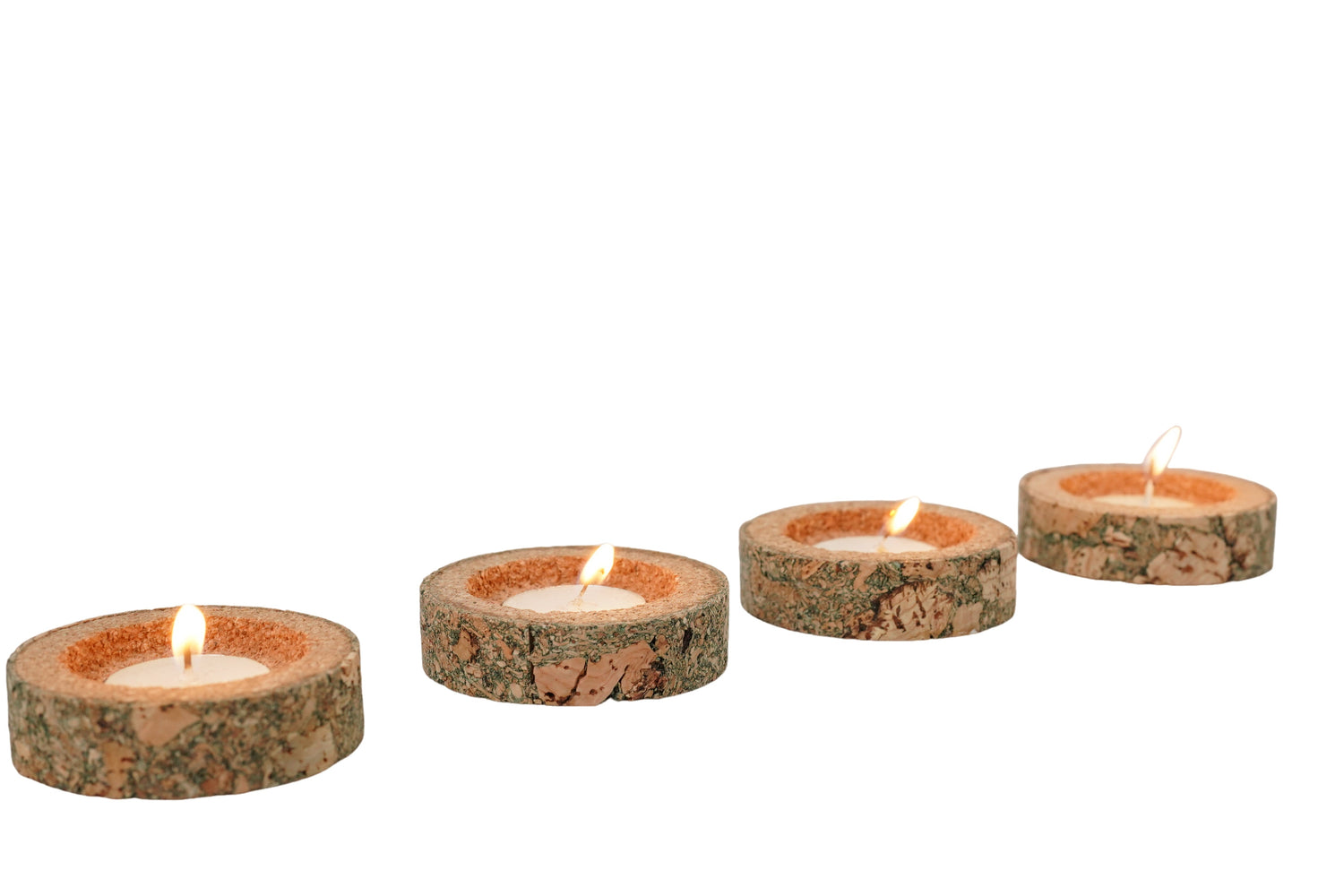 Set of four stone-look candles on a white background