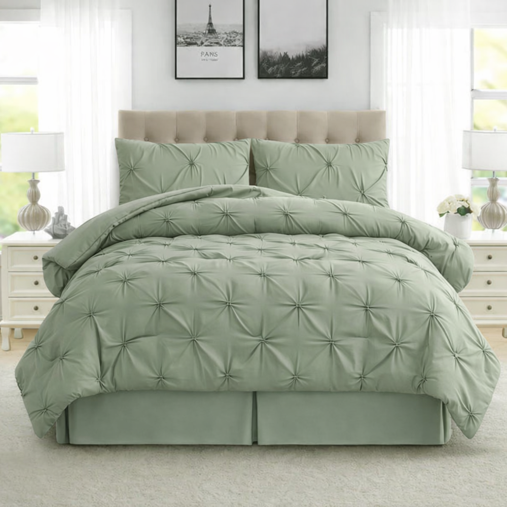 Green comforter set on a bed in a well-lit room with white walls and furniture.