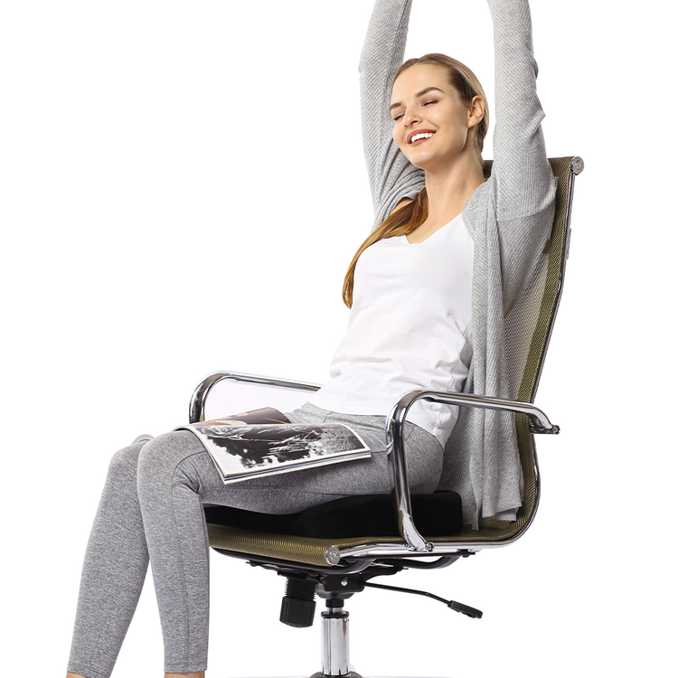 Woman sitting in a chair with a hammock-like device over her, on a white background