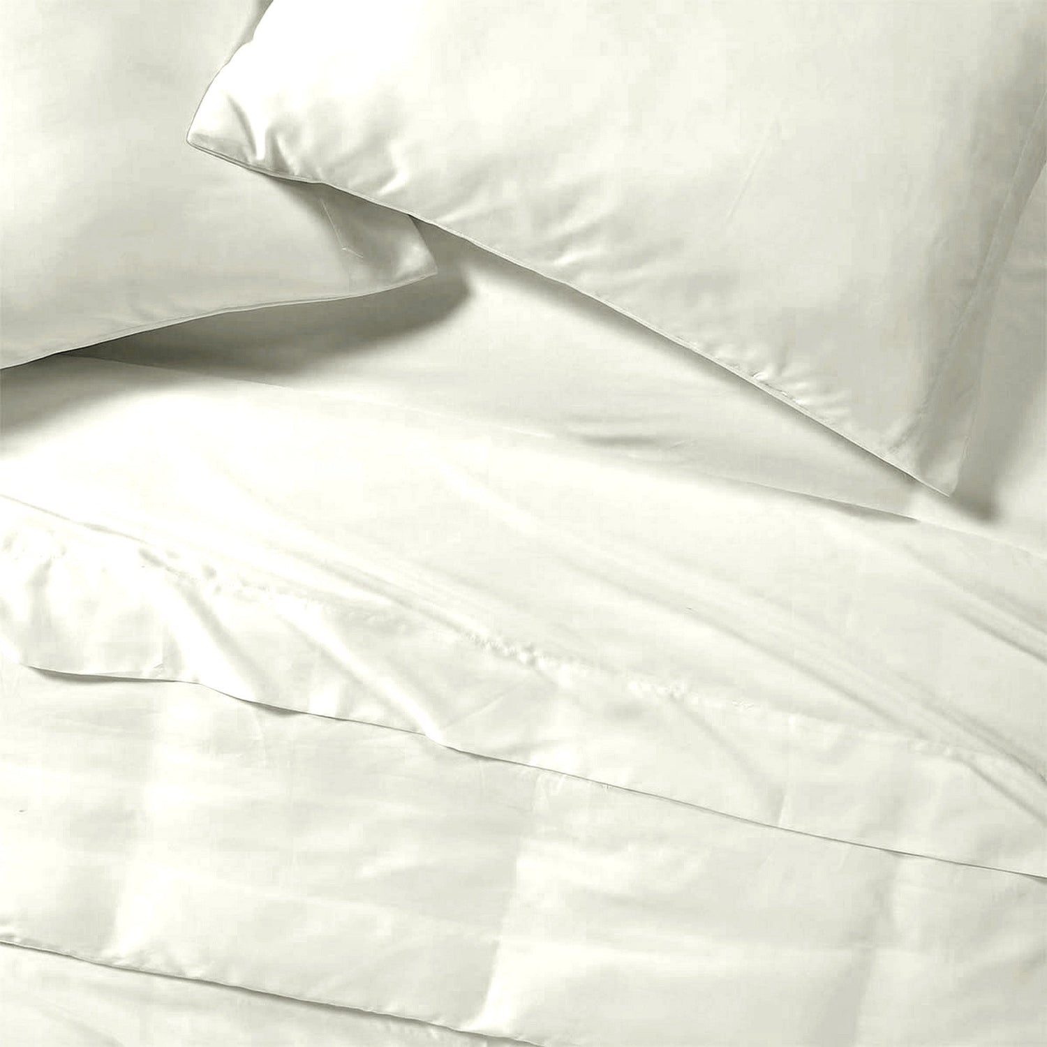 White satin pillowcases on a white bedspread