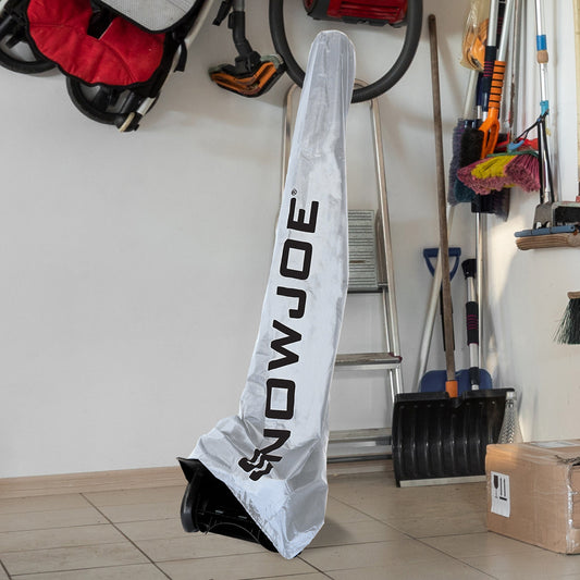 A long, narrow white snowmobile cover with black 'SNOWJOE' branding, shown on a white background with a circular inset showing the cover hanging in a garage.