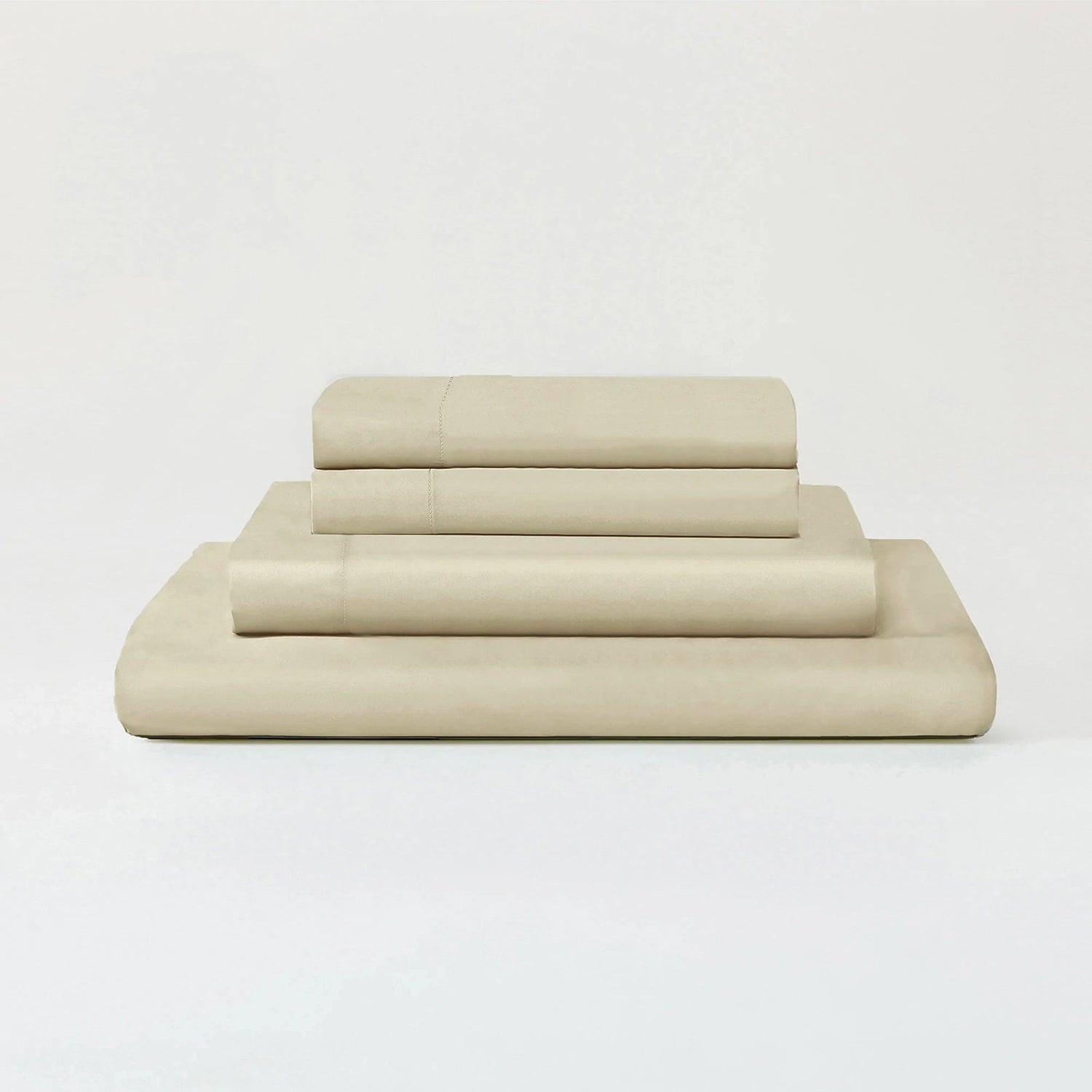 Beige bed sheets set on a white background