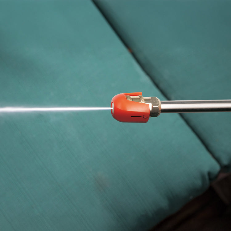 Red spray nozzle on a green surface