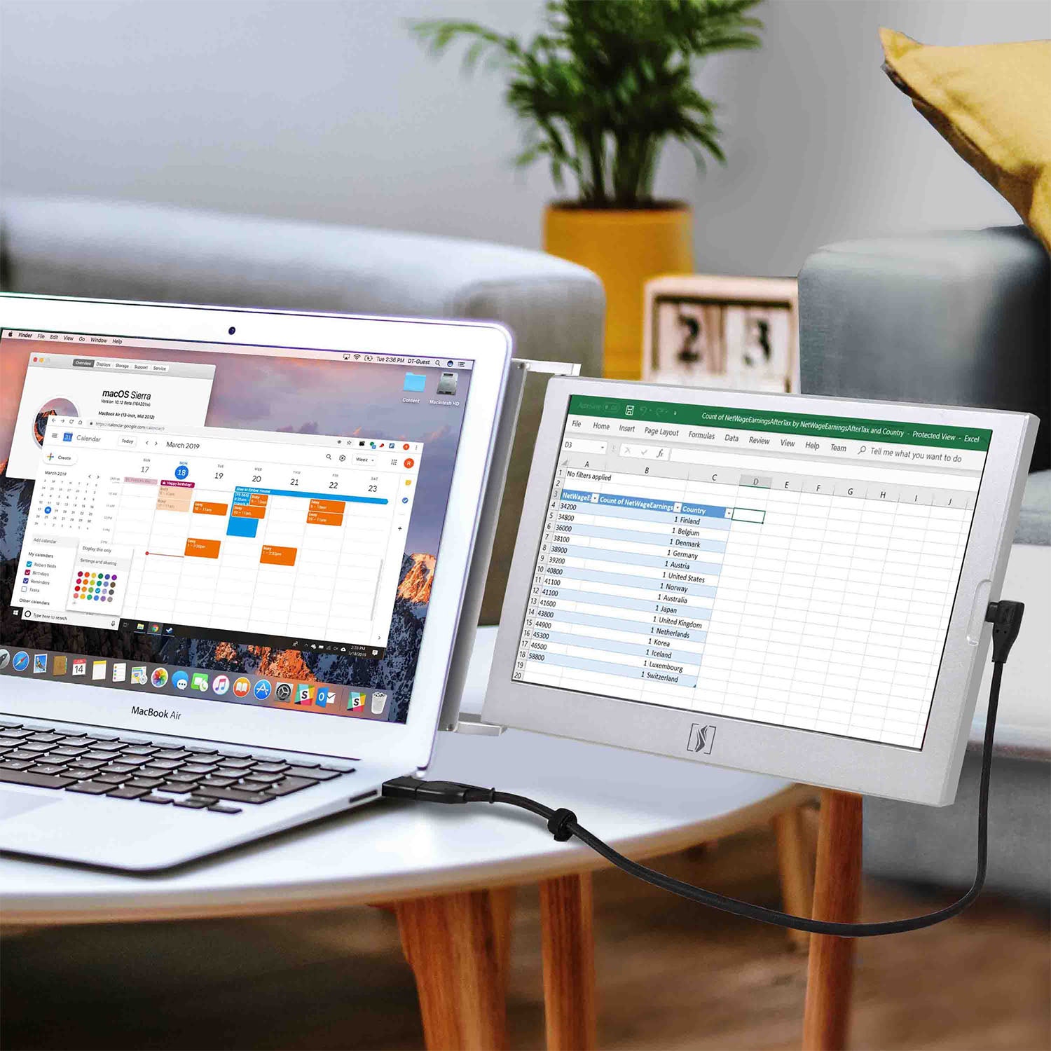 Laptop connected to a monitor displaying two open applications on a table in a home setting.