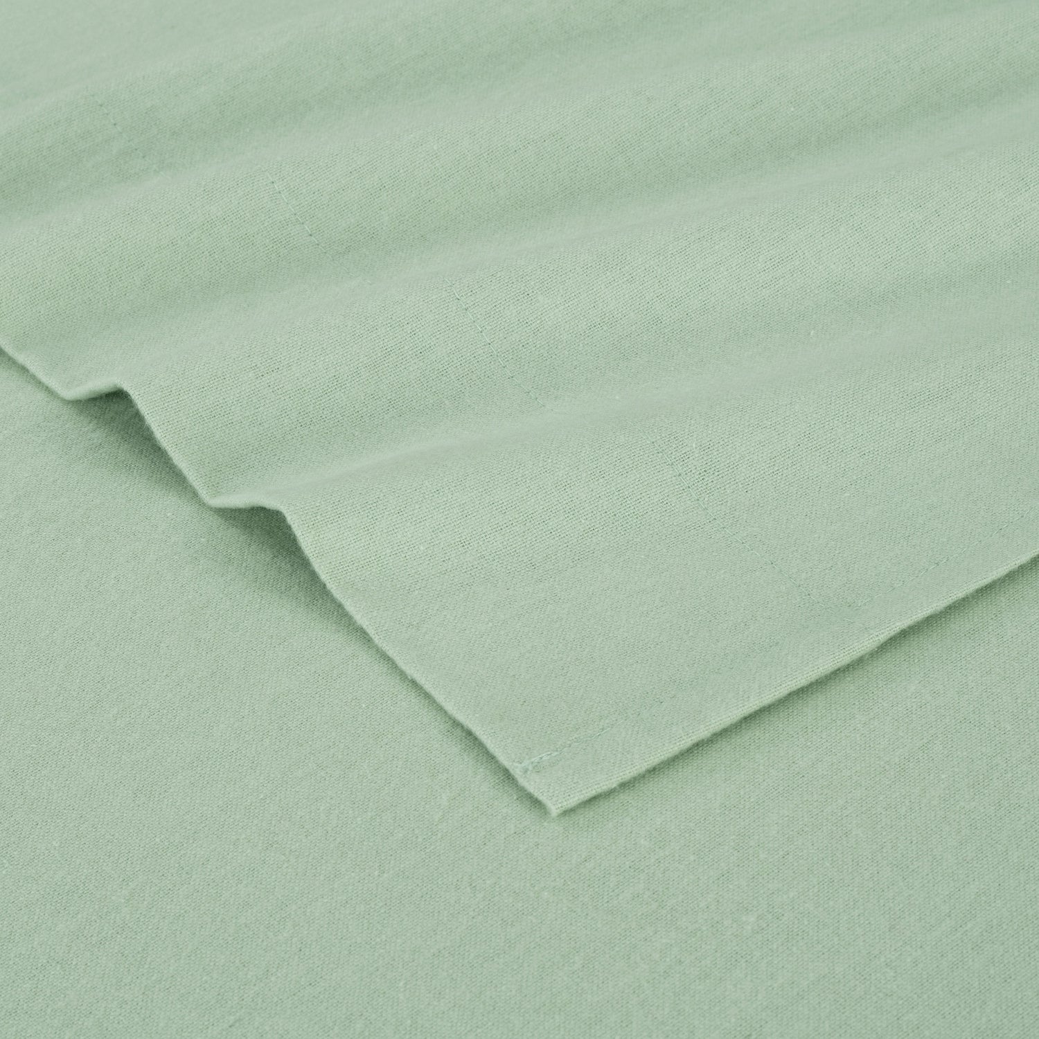 Close-up of light green fabric with a slight texture