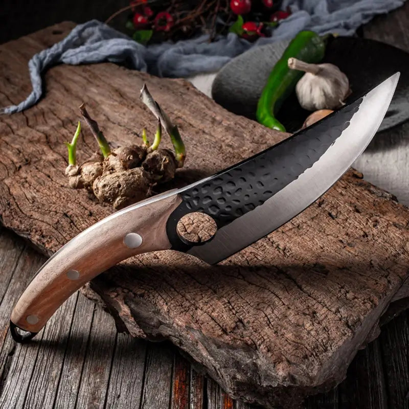 A picture of a cutting board with a Kyodai Utility Chef Knife from Seido Knives, surrounded by mushrooms.