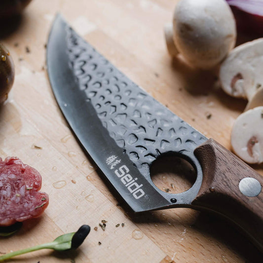 A Kyodai Utility Chef Knife and fresh mushrooms on a cutting board, ready for a delicious culinary adventure!