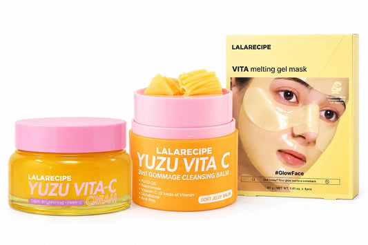 Lalarecipe skincare set featuring a yellow Yuzu Vita-C Cream jar with a pink lid, a yellow and orange Yuzu Vita C Soft Gommage Cleansing Balm jar with a pink lid and yellow gommage cubes visible, and a yellow box of LALARECIPE VITA melting gel mask on a white background.