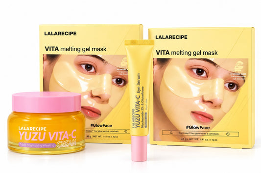 Lalarecipe Yuzu Vita-C Cream and VITA Melting Gel Mask set, featuring a yellow jar with a pink lid, a yellow tube with a pink cap, and yellow boxes with model imagery, arranged on a white background.