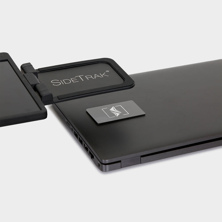 Black SideTrak device attached to a laptop on a white background